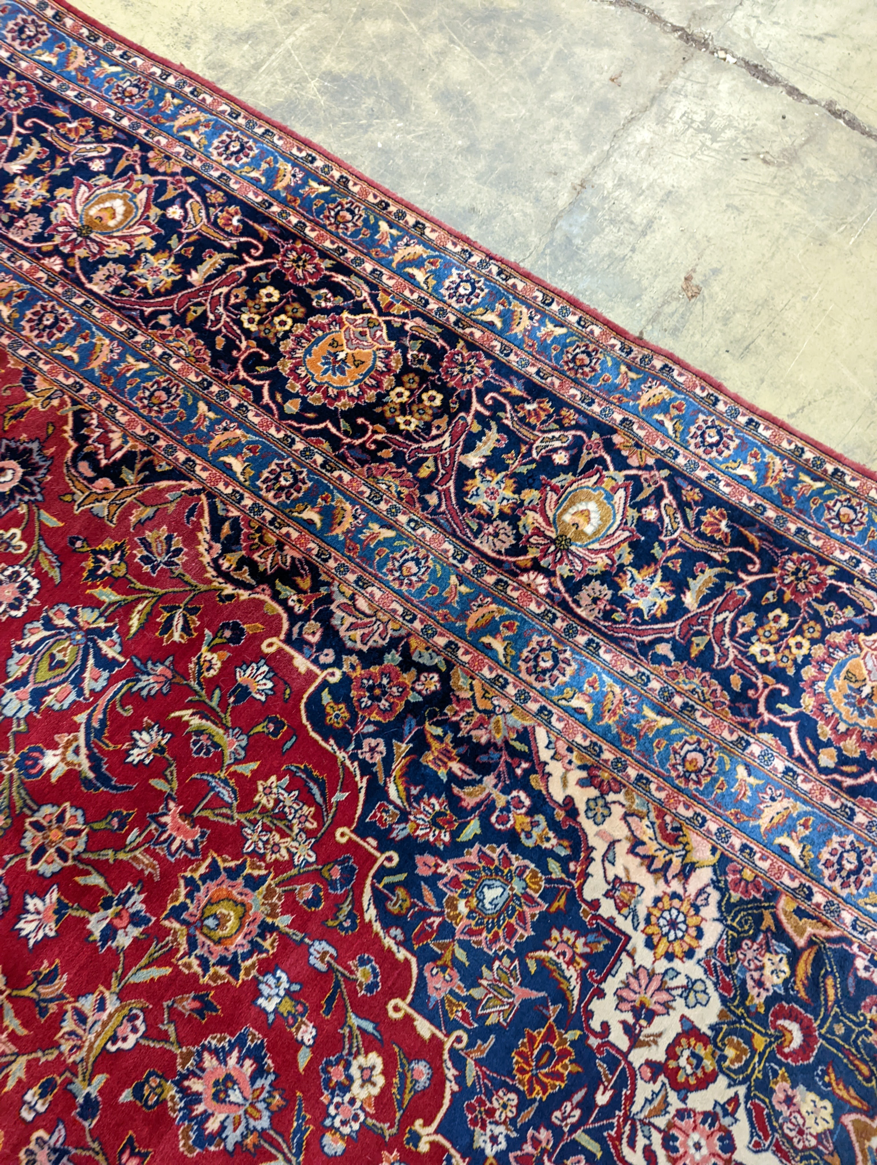 A large Tabriz red ground floral carpet, 540 x 350cm